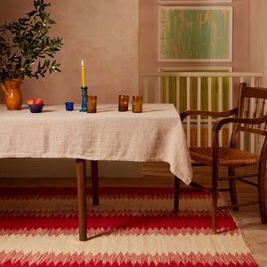 red and creme handwoven Afghan wool rug in dining room